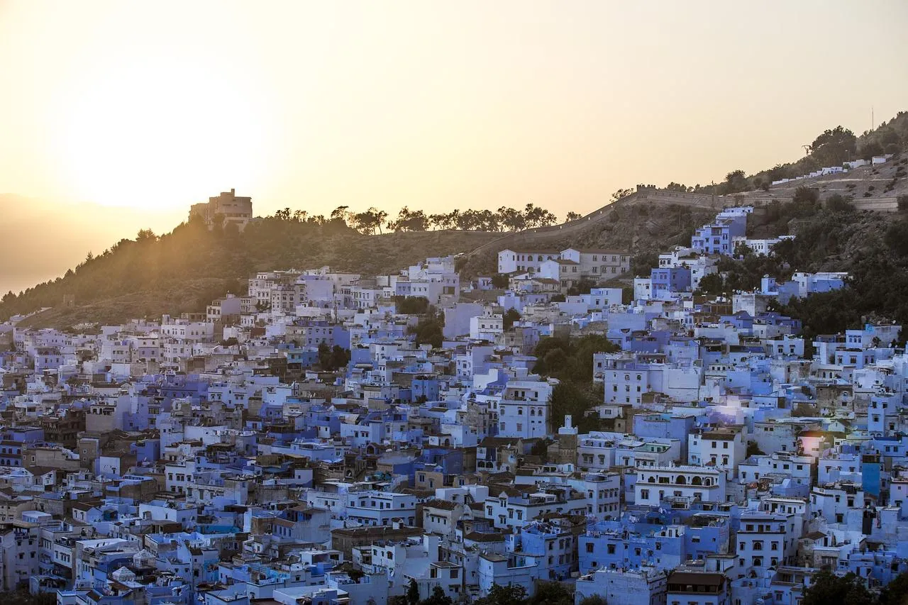 The blue town of Chefchaouen on the hillside at sunset