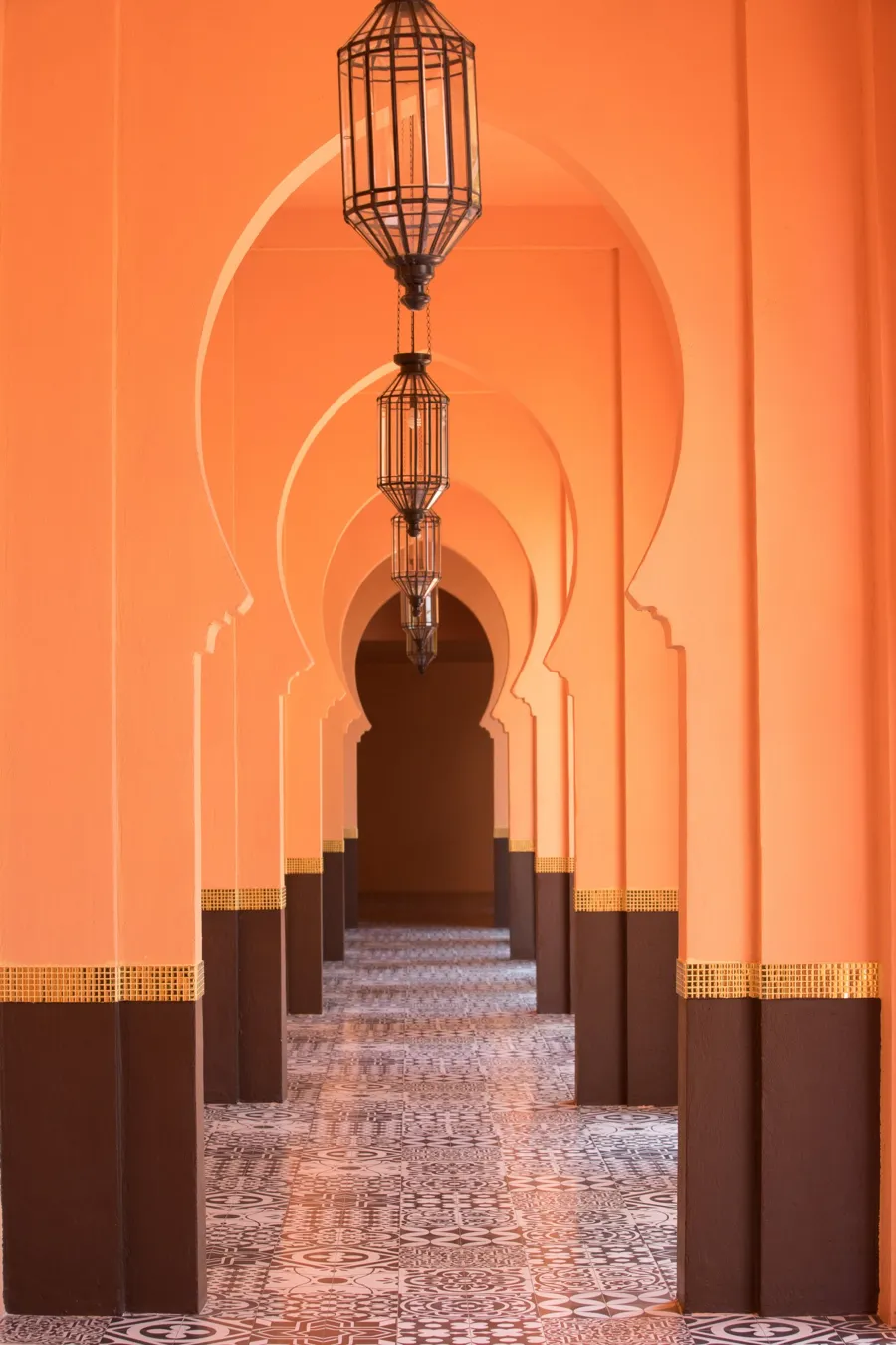 Orange Moroccan corridor with hanging lanterns