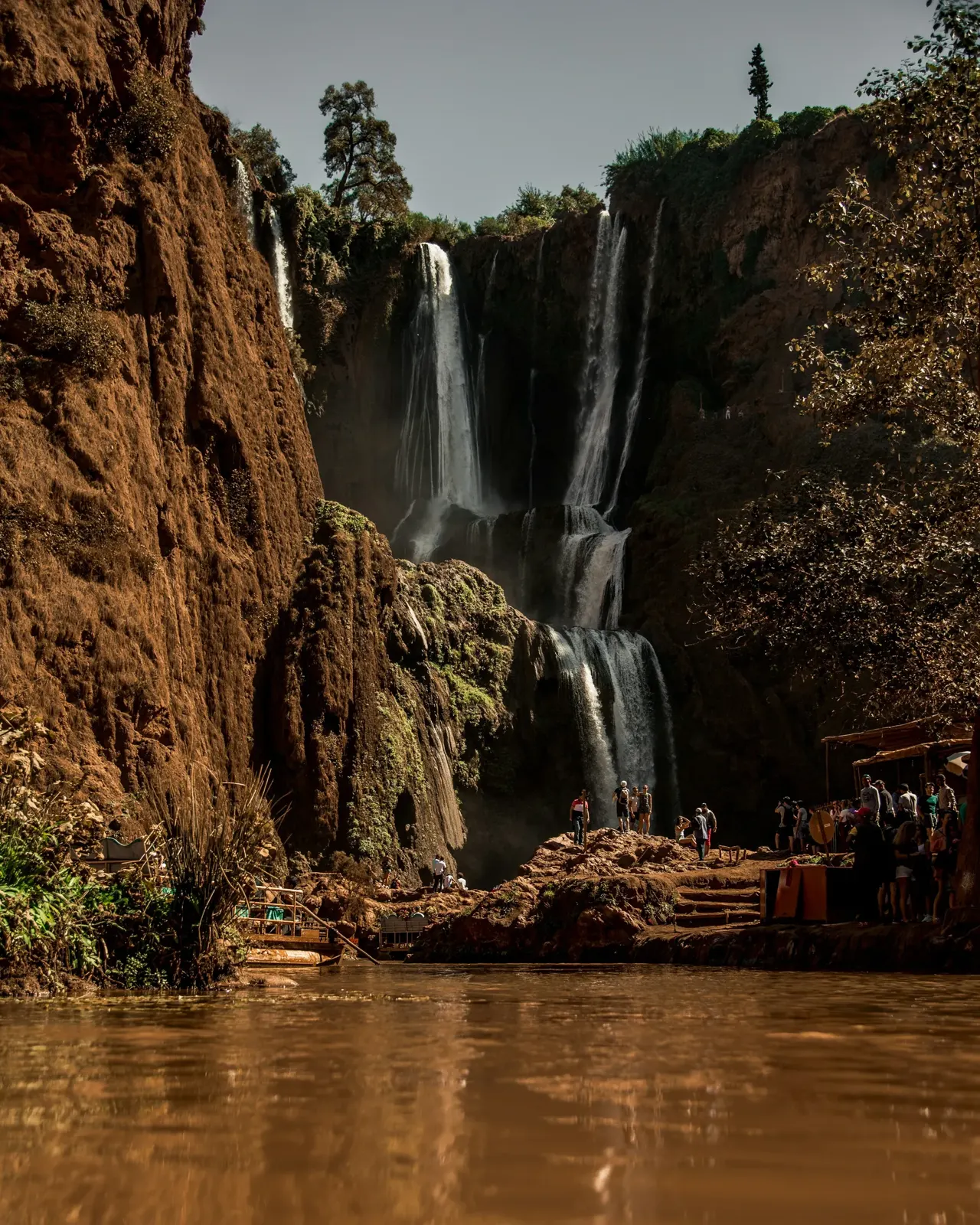 The Ouzoud waterfalls dropping into a green river gorge